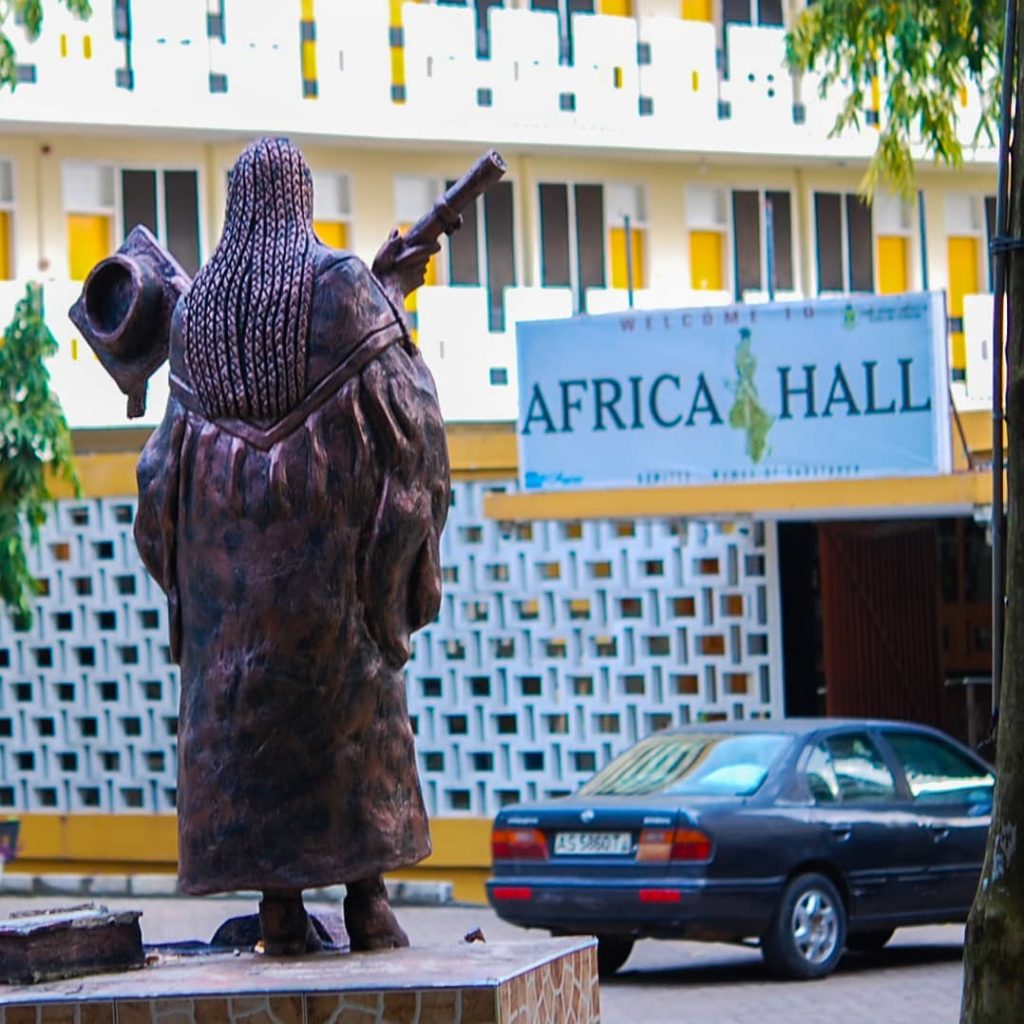 Statue holding certificate and cap at entrance of Africa Hall