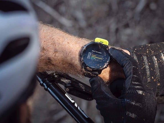 Biker looks at his Suunto Sports Smartwatch