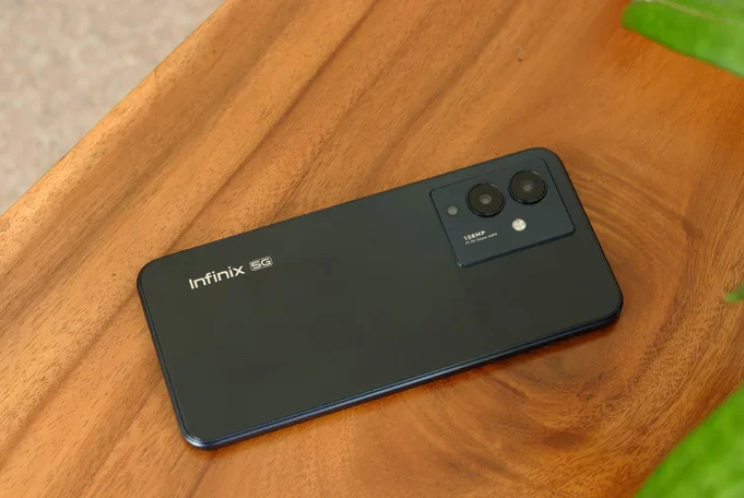 Infinix Note 12 Pro 5G unit in black colour lying on a wooden table