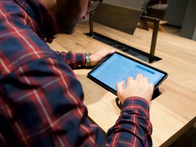 man sitting with tablet on table