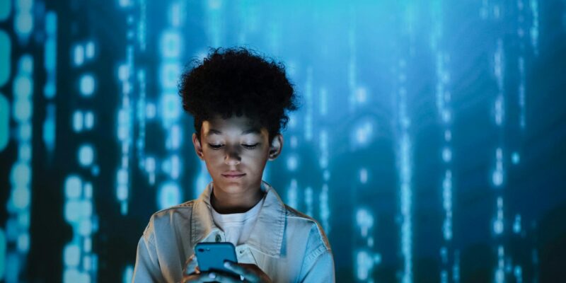 a boy using a mobile phone
